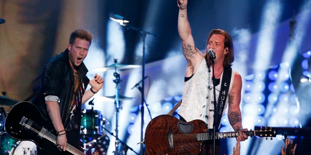 Brian Kelley (L) and Tyler Hubbard of Florida Georgia Line perfom "Stay" during the 4th annual American Country Awards in Las Vegas, Nevada December 10, 2013.   REUTERS/Lucy Nicholson (UNITED STATES  - Tags: ENTERTAINMENT)   - RTX16DAR