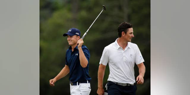 FILE - In this April 12, 2015, file photo, Jordan Spieth, left, celebrates after winning the Masters golf tournament in Augusta, Ga., as Justin Rose, of England, walks away. Spieth is competing in match play for the second time this month. The first occasion was only in his mind. He was five shots clear of Rose when he made the turn at Augusta National and was trying to keep his mind off the green jacket ceremony. So he told himself he was 1 down to Rose in match play and "let's play against him and see what we can do to get back." (AP Photo/Chris Carlson, File)