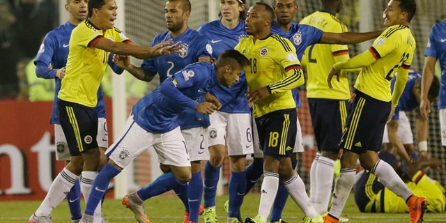 Colombia's Carlos Bacca, second left, pushes Brazil's Neymar, center right, at the end of the Copa America Group C soccer match at the Monumental stadium in Santiago, Chile, Wednesday, June 17, 2015. Colombia won the match 1-0 and Bacca and Neymar where both sent off with a red card at the end of the match. (AP Photo/Ricardo Mazalan)