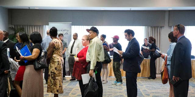 In this June 23, 2014 photo, people wait in line to meet with recruiters during a job fair in Philadelphia. The Labor Department reports on the number of people who applied for unemployment benefits last week on Thursday, Aug. 21, 2014. (AP Photo/Matt Rourke)