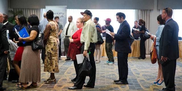 In this June 23, 2014 photo, people wait in line to meet with recruiters during a job fair in Philadelphia. The Labor Department reports on the number of people who applied for unemployment benefits last week on Thursday, Aug. 21, 2014. (AP Photo/Matt Rourke)