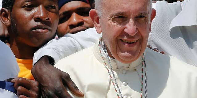 Pope Francis poses for a family picture with migrants of the San Francesco association at the end of his weekly general audience in St. Peter's Square at the Vatican, Wednesday, June 8, 2016. (AP Photo/Fabio Frustaci)