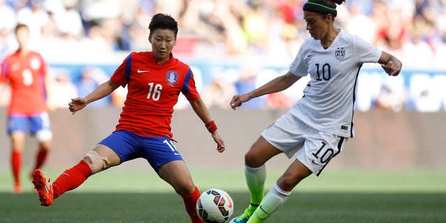 United States midfielder Carli Lloyd, right, controls the ball against South Korea midfielder Kwon Hahnul during the first half of an international friendly soccer match, Saturday, May 30, 2015, in Harrison, N.J. (AP Photo/Julio Cortez)