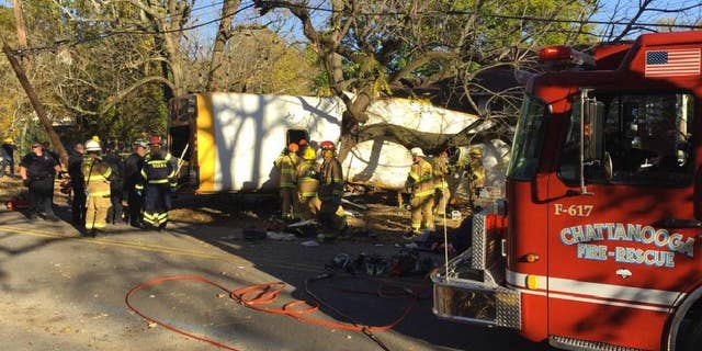 In this photo provided by the Chattanooga Fire Department via Chattanooga Times Free Press, Chattanooga Fire Department members work the scene of a fatal elementary school bus crash in Chattanooga, Tenn., Monday, Nov. 21, 2016. In a news conference Monday, Assistant Chief Tracy Arnold said there were multiple fatalities in the crash. (Bruce Garner/Chattanooga Fire Department via Chattanooga Times Free Press via AP)