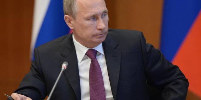 Russian President Vladimir Putin listens during a meeting on development of the Russian Far East issues in Yakutsk, Russia, Monday, Sept. 1, 2014. Russian President Vladimir Putin on Sunday called on Ukraine to immediately start talks on a political solution to the crisis in eastern Ukraine. (AP Photo/RIA Novosti, Alexei Nikolsky, Presidential Press Service)