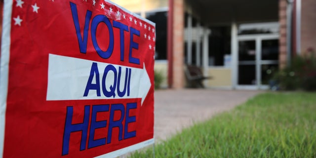 AUSTIN, TX - APRIL 28: A bilingual sign stands outside a polling center at public library ahead of local elections on April 28, 2013 in Austin, Texas. Early voting was due to begin Monday ahead of May 11 statewide county elections. The Democratic and Republican parties are vying for the Latino vote nationwide following President Obama's landslide victory among Hispanic voters in the 2012 election. (Photo by John Moore/Getty Images)