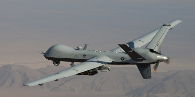 In this undated handout file photo provided by the U.S. Air Force, an MQ-9 Reaper, armed with GBU-12 Paveway II laser guided munitions and AGM-114 Hellfire missiles, is piloted by Col. Lex Turner during a combat mission over southern Afghanistan.