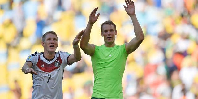Germany's Bastian Schweinsteiger, left, and goalkeeper Manuel Neuer celebrate at the end of the World Cup quarterfinal soccer match between Germany and France at the Maracana Stadium in Rio de Janeiro, Brazil, Friday, July 4, 2014. Germany won the match 1-0. (AP Photo/Martin Meissner)