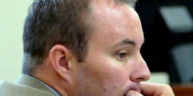 FILE - In this Aug. 17, 2015, file photo, Charlotte-Mecklenburg police Officer Randall "Wes" Kerrick sits at the defense table during his manslaughter trial in Charlotte, N.C. State attorneys on Friday, Aug. 28, 2015, decided against retrying Kerrick, who shot and killed an unarmed black man after his trial ended in a deadlock last week. (Davie Hinshaw/The Charlotte Observer via AP, Pool, File)