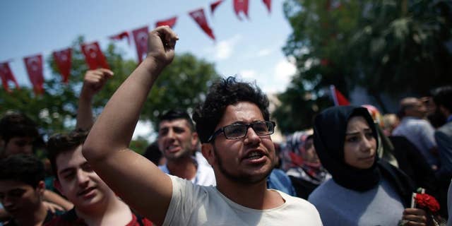 June 8, 2016: People shout to condemn terrorism as they visit the site of Tuesday explosion in Istanbul.