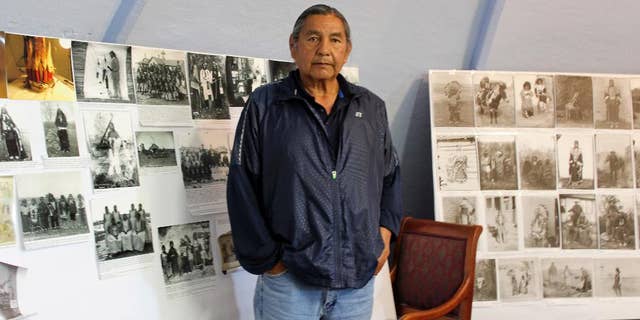 In this May 6, 2016, file photo, Russell Eagle Bear, the historic preservation officer for the Rosebud Sioux Tribe, stands in his office in in Rosebud, S.D. A group of tribes pushing to place Pe' Sla, a site that's sacred to the Great Sioux Nation, into a federal trust has come up against the state of South Dakota. The state in April appealed a federal decision to take the land purchased by the tribes into trust. (AP Photo/Regina Garcia Cano, File)