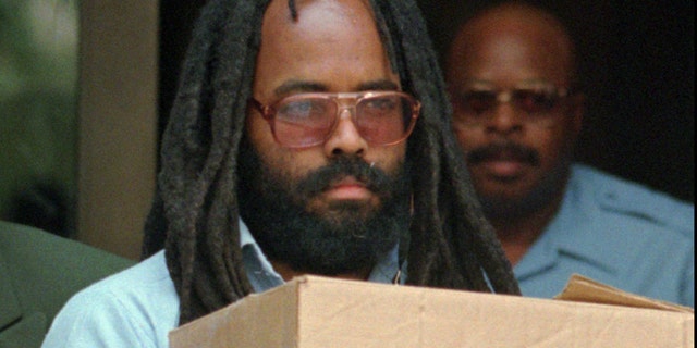Mumia Abu-Jamal leaves Philadelphia's City Hall after a hearing in 1995. (AP)