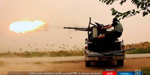 An ISIS fighter firing his weapon in Raqqa, Syria.