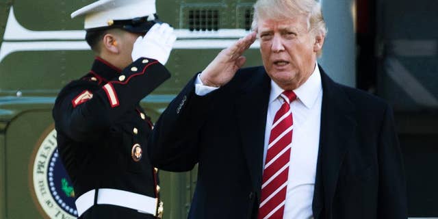 FILE - In this Monday, Feb. 6, 2017, file photo, U.S. President Donald Trump salutes a Marines honor guard as he disembarks from Marine One upon arrival at the White House in Washington. A top Chinese judge has labeled Donald Trump an enemy “of the rule of law” over his insults directed at a U.S. judge who temporarily blocked the president’s travel ban. The blog post by Supreme People’s Court Judge He Fan came after Trump went on Twitter to denigrate James Robart as a “so-called judge” whose “ridiculous” decision opened the country to potential terror attacks. (AP Photo/Manuel Balce Ceneta, File)