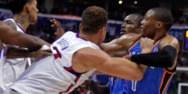 Los Angeles Clippers forward Matt Barnes, left and Clippers forward Blake Griffin, second from left, tangle with Oklahoma City Thunder forward Serge Ibaka, second from right, of Congo, and Thunder guard Russell Westbrook, right, in the first half of their NBA basketball game Wednesday, Nov. 13, 2013, in Los Angeles. Ibaka and Barnes were ejected from the game after the scuffle. (AP Photo/Alex Gallardo)