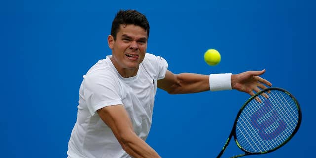 Canada's Milos Raonic makes a return to the Czech Republic's Jiri Vesely, during day four of the 2016 tennis Championships at The Queen's Club, London, Thursday June 16, 2016. (Steve Paston/PA via AP)  UNITED KINGDOM OUT