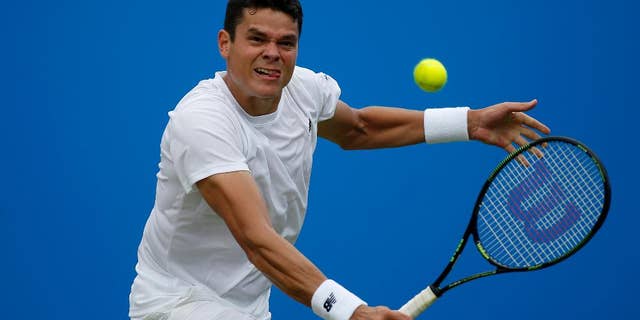 Canada's Milos Raonic makes a return to the Czech Republic's Jiri Vesely, during day four of the 2016 tennis Championships at The Queen's Club, London, Thursday June 16, 2016. (Steve Paston/PA via AP) UNITED KINGDOM OUT