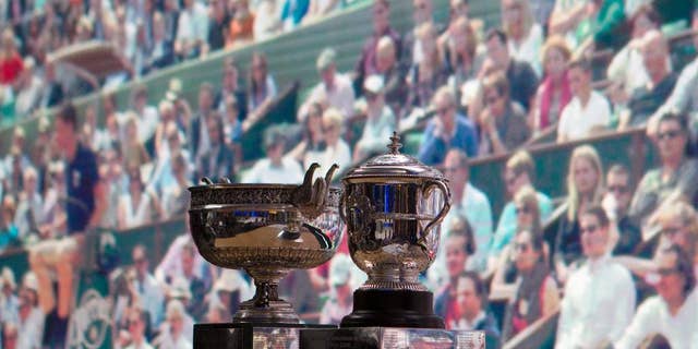 The men's cup, left, and women's cup are seen before the draw of the French Open tennis tournament at the Roland Garros stadium, Friday, May 20, 2016 in Paris. The French Open starts Sunday May 22. (AP Photo/Bertrand Combaldieu)