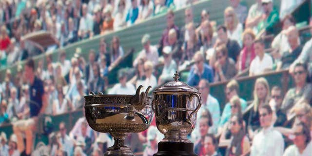 The men's cup, left, and women's cup are seen before the draw of the French Open tennis tournament at the Roland Garros stadium, Friday, May 20, 2016 in Paris. The French Open starts Sunday May 22. (AP Photo/Bertrand Combaldieu)