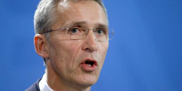 NATO Secretary General Jens Stoltenberg speaks during a joint press conference as part of a meeting with German Chancellor Angela Merkel at the chancellery in Berlin, Germany, Wednesday, Jan. 14, 2015. (AP Photo/Michael Sohn)