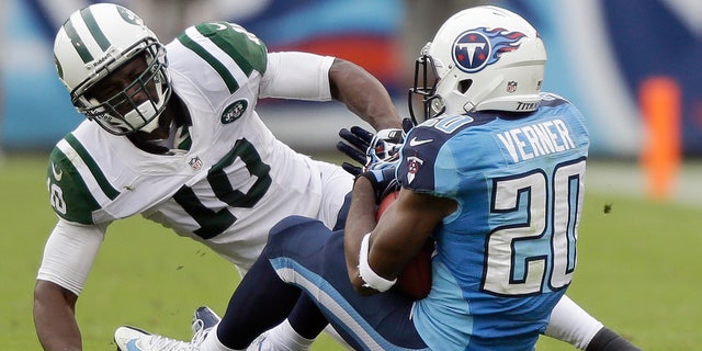 FILE - In this Sept 29, 2013, file photo, Tennessee Titans cornerback Alterraun Verner (20) intercepts a pass intended for New York Jets wide receiver Santonio Holmes (10) during the second quarter of an NFL football game in Nashville, Tenn. The Kansas City Chiefs and the Titans are tied for the most takeaways in the NFL. Well, actually Titans safety Michael Griffin says it's mostly cornerback Alterraun Verner, who leads the league with six takeaways all by himself. (AP Photo/Wade Payne, File)
