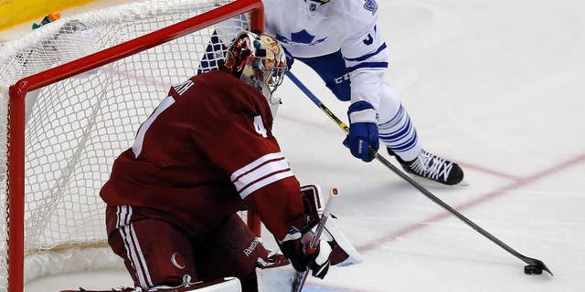 Toronto Maple Leafs right wing Carter Ashton (37) tries to score on Arizona Coyotes goalie Mike Smith during the third period during an NHL hockey game, Tuesday, Nov. 4, 2014, in Glendale, Ariz. Phoenix won 3-2. (AP Photo/Rick Scuteri)