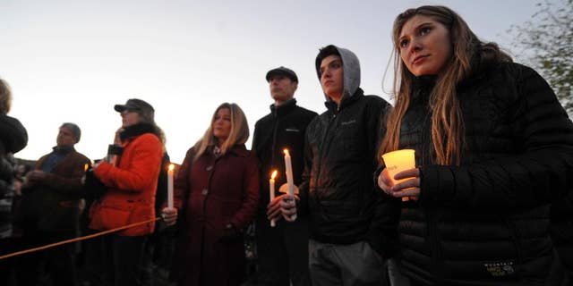 Mourners hold candles Monday, Oct. 10, 2016, during a vigil attended by about 1,000 at Harwood Union High School in Duxbury, Vt., held for the teenaged victims killed in Saturday night's crash on Interstate 89 in Williston. Four of the five teens killed by the wrong-way driver were students at Harwood. The fifth student killed was from Fayston and attended a private school in New Hampshire. (Stefan Hard/Times Argus via AP)