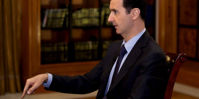 In this photo, which AP obtained from Syrian official news agency SANA and which has been authenticated based on its contents and other AP reporting, President Bashar Assad gestures as he speaks during an interview with Lebanon’s Al-Mayadeen TV, at the presidential palace in Damascus, Syria, Monday, Oct. 21, 2013. Syria’s president said Monday that the factors that would allow a landmark conference aimed at ending the country’s civil war do not yet exist, throwing further doubt on international efforts to hold peace talks that have already been repeatedly delayed. (AP Photo/SANA)