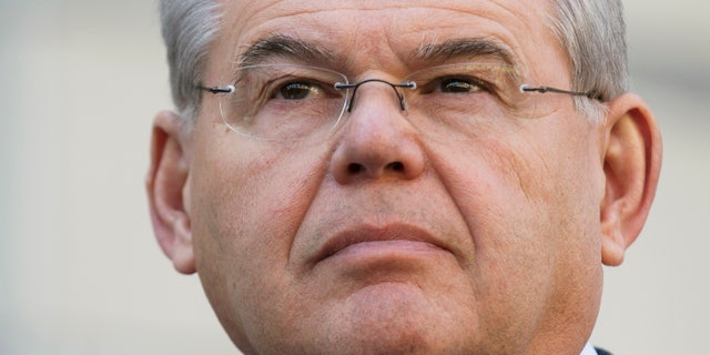 U.S. Sen. Bob Menendez waits to speak outside federal court, Thursday, April 2, 2015, in Newark, N.J.
