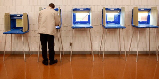 MILWAUKEE, WI - NOVEMBER 06: A man casts' his ballot in the U.S. presidential election on November 6, 2012 in Milwaukee, Wisconsin. As Americans are heading to the ballots, polls show that U.S. President Barack Obama and Republican presidential candidate Mitt Romney are in a tight race. (Photo by Darren Hauck/Getty Images)