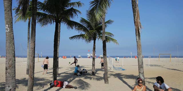 People sleep, play soccer, and relax on the Copacabana beach in Rio de Janeiro, Brazil, Monday, June 16, 2014. Rio de Janeiro is one of the host cities for the 2014 World Cup soccer tournament.(AP Photo/Wong Maye-E)