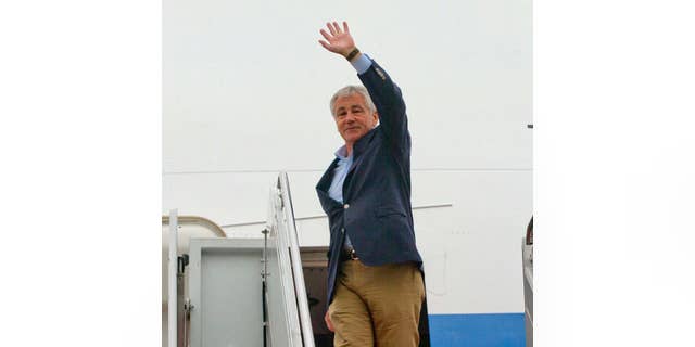 Defense Secretary Chuck Hagel waves as he boards his plane before his departure at Joint Base Elmendorf-Richardson, Alaska, Thursday, May 29, 2014. Hagel is on a 12-day trip to Asia and Europe, his fourteenth international trip, and is traveling the Shangri La Dialogue to discuss key regional and global issues with leaders of several countries. (AP Photo/Pablo Martinez Monsivais, Pool)
