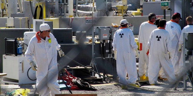 July 14, 2010: In this photo, workers at the Hanford nuclear reservation work around a a tank farm where highly radioactive waste is stored underground near Richland, Wash.