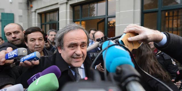 UEFA-President Michel Platini of France is surrounded by media after a hearing at the international Court of Arbitration for Sport, CAS, in Lausanne, Switzerland, Tuesday, Dec. 8, 2015. Platini appealed against a 90-day ban which is keeping him out of the presidential race for the sport's scandal-plagued governing body FIFA. (Laurent Gillieron/Keystone via AP)