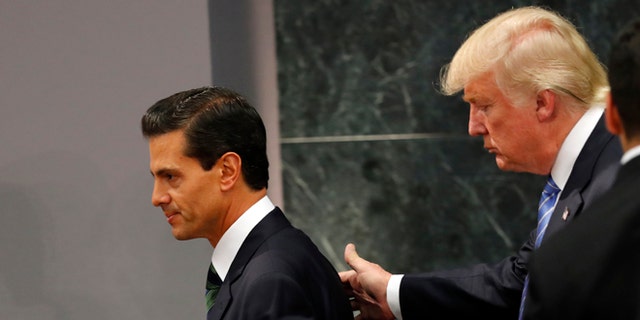 Republican presidential nominee Donald Trump walks with Mexico President Enrique Pena Nieto at the end of their joint statement at Los Pinos, the presidential official residence, in Mexico City, Wednesday, Aug. 31, 2016. Trump is calling his surprise visit to Mexico City Wednesday a 'great honor.'  The Republican presidential nominee said after meeting with PeÃÂ±a Nieto that the pair had a substantive, direct and constructive exchange of ideas.(AP Photo/Dario Lopez-Mills)