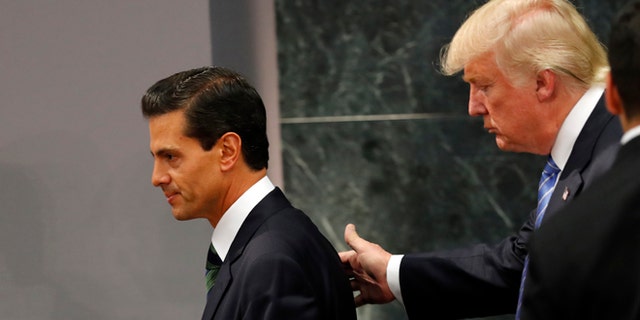 Republican presidential nominee Donald Trump walks with Mexico President Enrique Pena Nieto at the end of their joint statement at Los Pinos, the presidential official residence, in Mexico City, Wednesday, Aug. 31, 2016. Trump is calling his surprise visit to Mexico City Wednesday a 'great honor.' The Republican presidential nominee said after meeting with Peña Nieto that the pair had a substantive, direct and constructive exchange of ideas.(AP Photo/Dario Lopez-Mills)