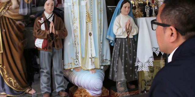 The statuettes of brother and sister Francisco and Jacinta, whom Pope Francis will canonize, is displayed in Fatima, Portugal, on May 12, 2017.