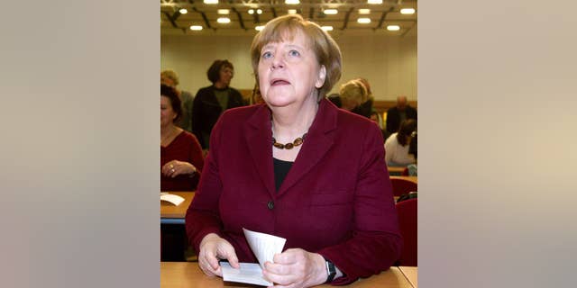 German Chancellor Angela Merkel attends a local meeting of her Christian Democrats, CDU, in Grimmen, northern Germany, Saturday, Jan. 28, 2017. Merkel said there's no solution yet to the problem of how to fairly share the burden of migration among European Union member states. (Stefan Sauer/dpa via AP)