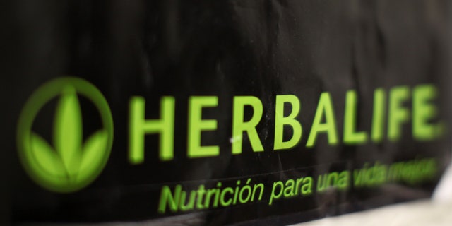 An Herbalife logo is shown on a poster at a clinic in the Mission District in San Francisco, California April 29, 2013. Herbalife Ltd posted surprisingly strong quarterly earnings and raised its full-year profit forecast on Monday, putting pressure on high-profile investor Bill Ackman, who is betting against the nutritional products company REUTERS/Robert Galbraith (UNITED STATES - Tags: SOCIETY BUSINESS) - RTXZ4KH
