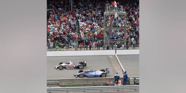 Al Unser Jr., in the lead, overtook Scott Goodyear to win his first 500 miles of Indianapolis in 1992. (AP Photo / David Boe, File)