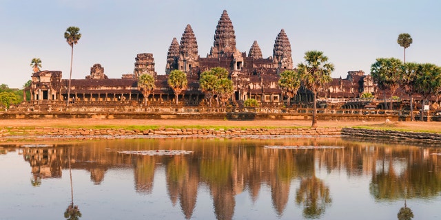 "A panoramic view of the spectacular ruins of the Angkor Wat temple complex in Cambodia. Taken in golden evening light just before sunset, the scene is reflected in the large lotus pond in front.See several more from Angkor Cambodia, plus Vietnam and Laos:"