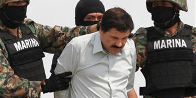Guzman is escorted to a helicopter by Mexican navy marines in Mexico City, Saturday, Feb. 22, 2014.