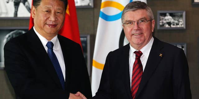 Chinese President Xi Jinping, left, shakes hand with International Olympic Committee, IOC, President Thomas Bach, right, before a meeting at the Olympic Museum in Lausanne, Switzerland, Wednesday, Jan. 18, 2017. (Denis Balibouse/Pool Photo via AP)