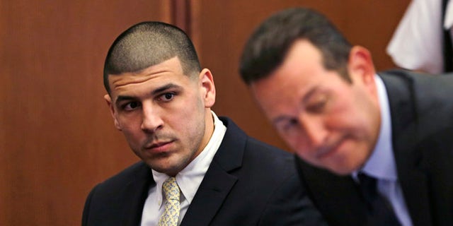 FILE - In this Thursday, July 21, 2016 file photo, Former New England Patriots wide receiver Aaron Hernandez, left, looks down the table at his legal team as his new defense attorney Jose Baez, right, takes a seat during a court appearance at Plymouth Superior Court in Plymouth, Mass. Hernandez is due in Suffolk Superior Court on Tuesday, Aug. 16, for a hearing in the 2012 killings of two men outside a Boston nightclub. Hernandez has pleaded not guilty. (AP Photo/Charles Krupa, Pool, File)