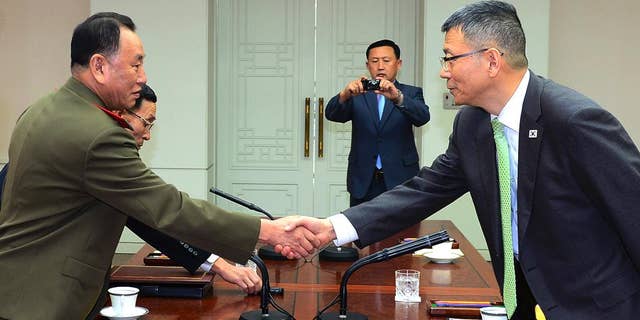 In this photo released by South Korean Defense Ministry, North Korean delegation chief Kim Yong Chol, left, shakes hands with his South Korean counterpart, Deputy Minister for National Defense Policy Ryu Je-seung during a meeting at the border village of Panmunjom, South Korea, Wednesday, Oct. 15, 2104.  The first military talks between North and South Korea in more than three years ended with no agreement Wednesday, with the rivals failing to narrow their differences on how to ease animosities following two shooting incidents last week, South Korean officials said. (AP Photo/Defense Ministry)