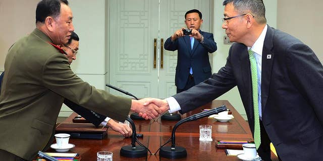 In this photo released by South Korean Defense Ministry, North Korean delegation chief Kim Yong Chol, left, shakes hands with his South Korean counterpart, Deputy Minister for National Defense Policy Ryu Je-seung during a meeting at the border village of Panmunjom, South Korea, Wednesday, Oct. 15, 2104. The first military talks between North and South Korea in more than three years ended with no agreement Wednesday, with the rivals failing to narrow their differences on how to ease animosities following two shooting incidents last week, South Korean officials said. (AP Photo/Defense Ministry)