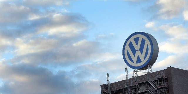 FILE - In this Sept. 26, 2015 file photo a giant logo of the German car manufacturer Volkswagen is pictured on top of a company's factory building in Wolfsburg, Germany. A German court says Wednesday, Sept. 21, 2016 it has added staff and storage space to handle a flood of 1,400 investor lawsuits against Volkswagen seeking damages worth 8.2 billion euros (US dollar 9.2 billion). (AP Photo/Michael Sohn, file)