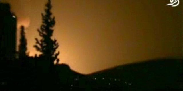 In this image taken from video obtained from Shaam News Network, which has been authenticated based on its contents and other AP reporting, smoke and fire fill the skyline over Damascus, Syria, early Sunday, May 5, 2013 after an Israeli airstrike. Israeli warplanes struck areas in and around the Syrian capital Sunday, setting off a series of explosions as they targeted a shipment of highly accurate, Iranian-made guided missiles believed to be on their way to Lebanon's Hezbollah militant group, officials and activists said. The attack, the second in three days, signaled a sharp escalation of Israel's involvement in Syria's bloody civil war. Syria's state media reported that Israeli missiles struck a military and scientific research center near the Syrian capital and caused casualties. (AP Photo/Shaam News Network via AP video)