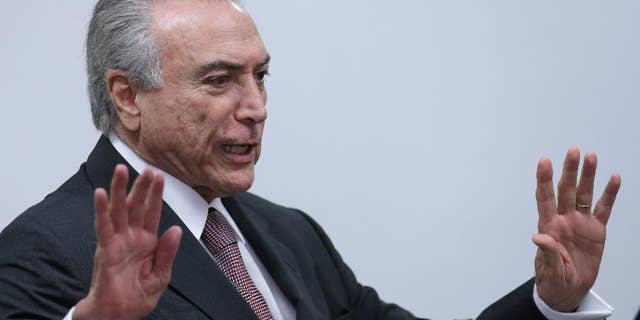 Brazil's acting President Michel Temer arrives to attend a meeting of ministers and military commanders on the preparations for the Rio 2016 Olympic Games, at the Planalto Presidential Palace, in Brasilia, Brazil, Monday, May 16, 2016. Temer assumed the presidency last week after President Dilma Rousseff was impeached and suspended for allegedly employing accounting tricks to hide gaping deficits in the federal budget. (AP Photo/Eraldo Peres)