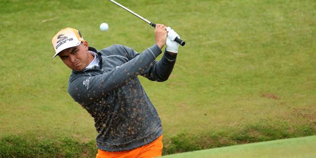 Rickie Fowler of the United States play out of a bunker on the 8th green during the final round of the British Open Golf Championship at the Royal Troon Golf Club in Troon, Scotland, Sunday, July 17, 2016. (AP Photo/Peter Morrison)